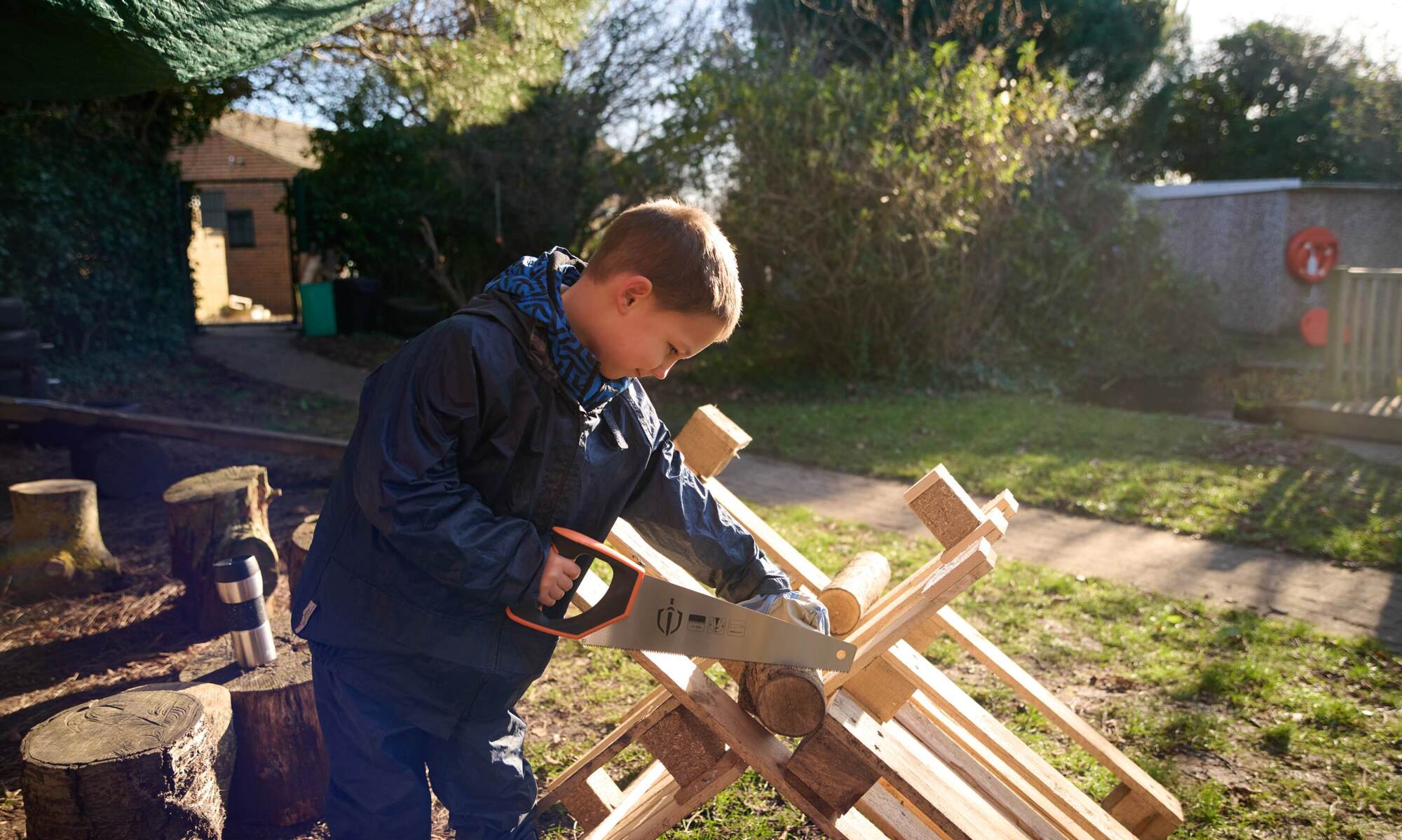 Forest School child with saw