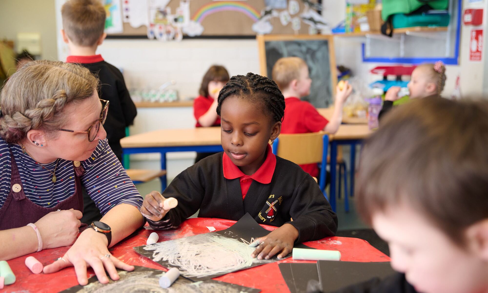 Child working with a member of staff